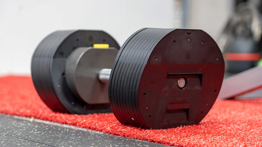 Regular picture of the adjustable dumbbells on the ground.