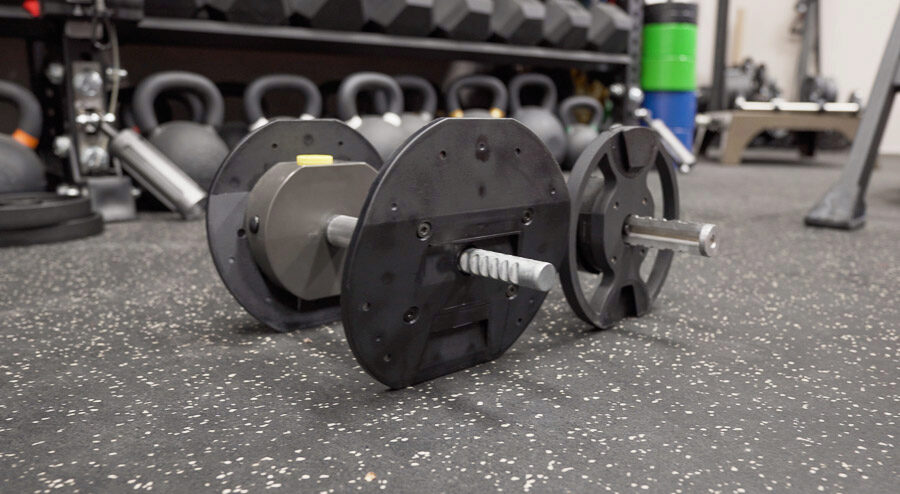 The inner workings of the adjustable dumbbells with the slim metal inside.