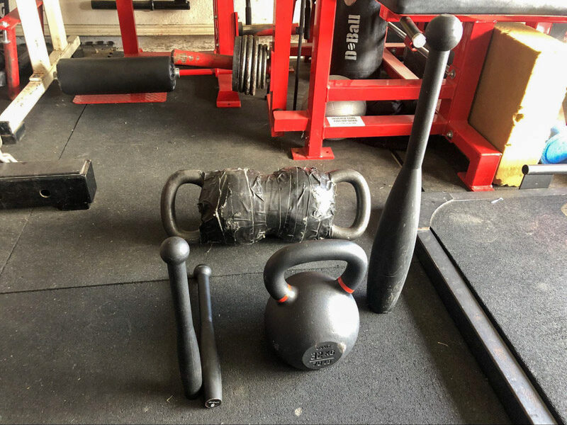 onnit Steel Clubs and kettlebell in a garage gym
