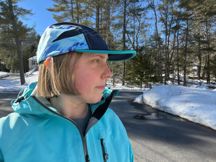 Woman wearing Nathan running hat featuring pockets for ice cubes