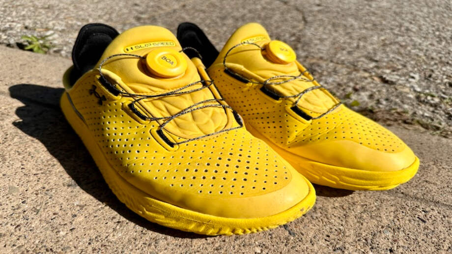A bold and beautiful yellow pair of Under Armour UA SlipSpeed training and recovery shoes.