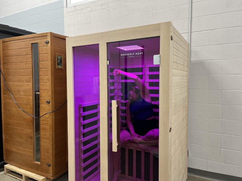 A woman stretches in a Heavenly Heat 1-Person Sauna