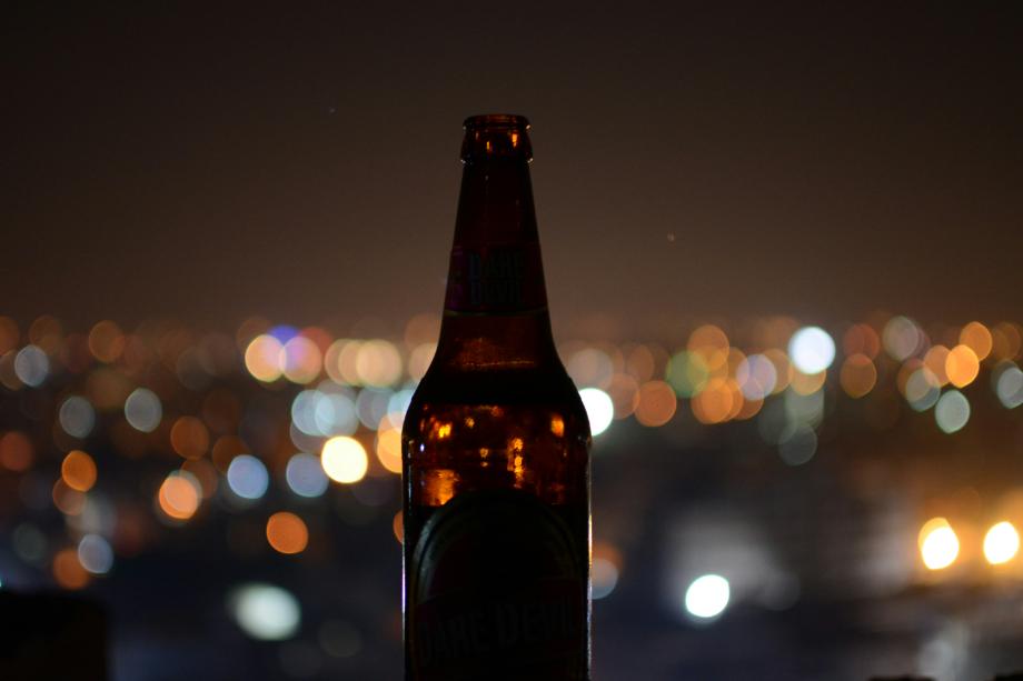 Photo of a longneck bottle against a city background for the 25 alcoholic beverages ranked by calories study