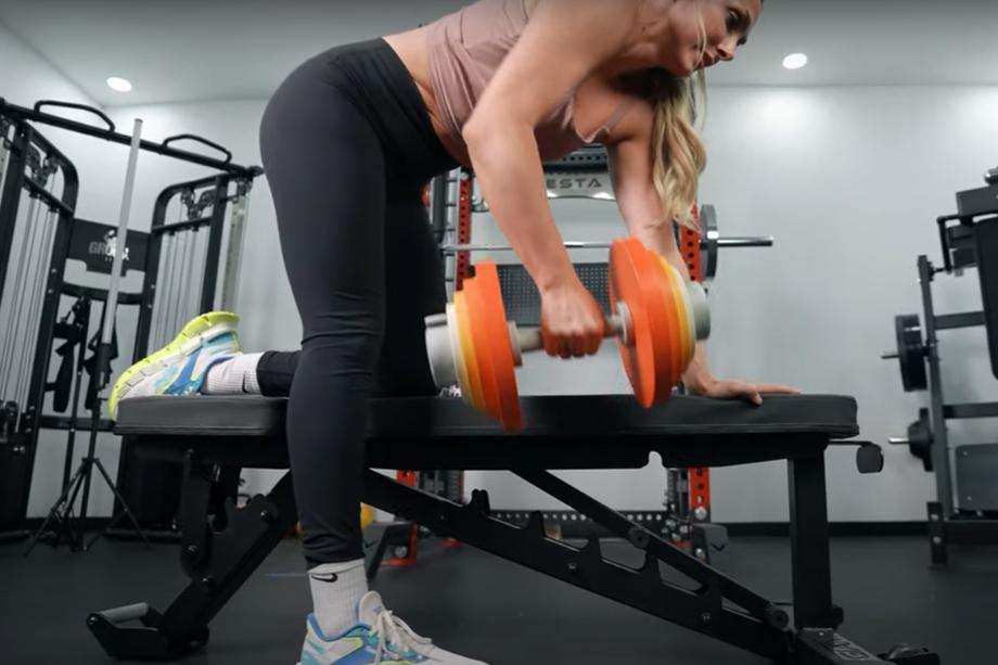 Lindsay Scheele, CPT does a one arm row with an Aviron Loadable Dumbbell