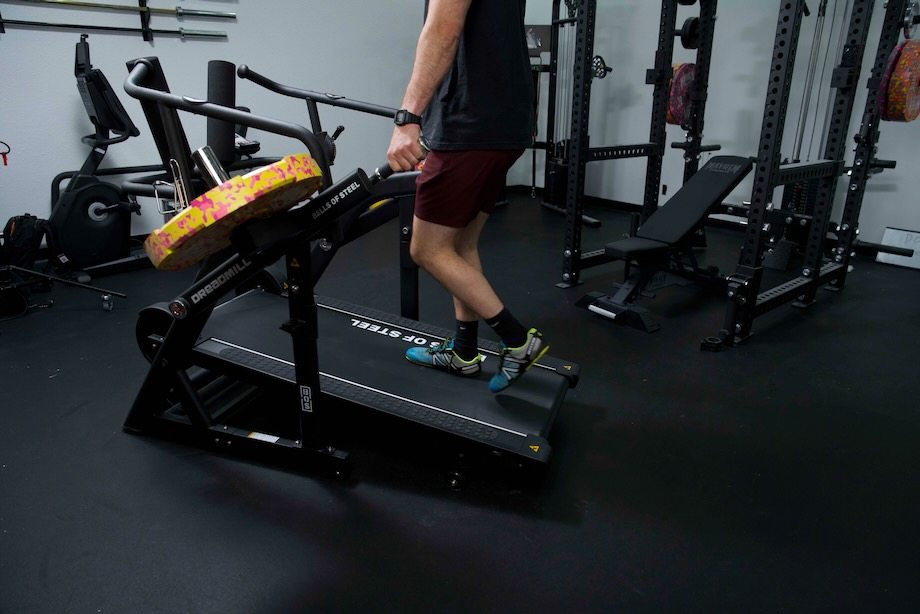 Coop tries a farmer's carry on the Bells of Steel Dreadmill.