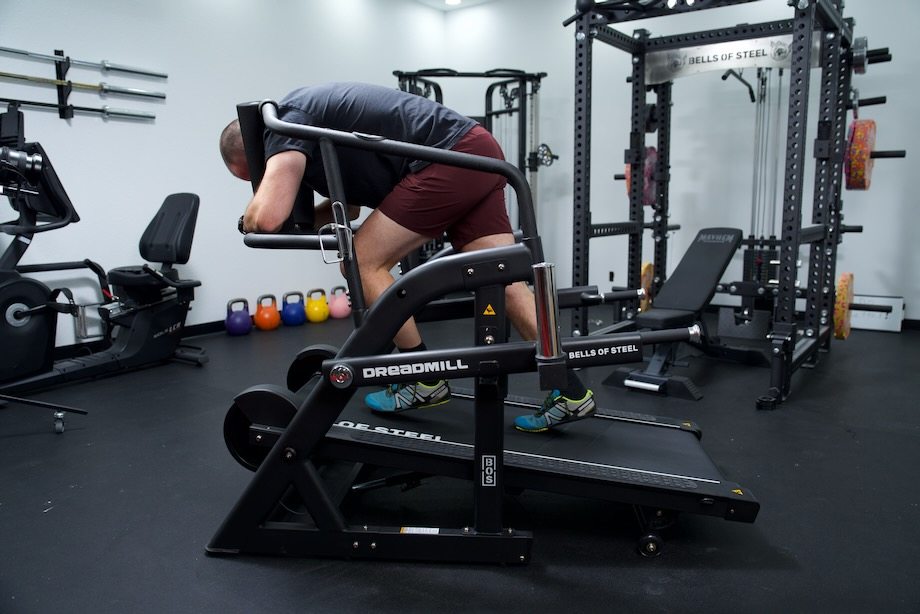 Coop leans into a sled push on the Bells of Steel Dreadmill.