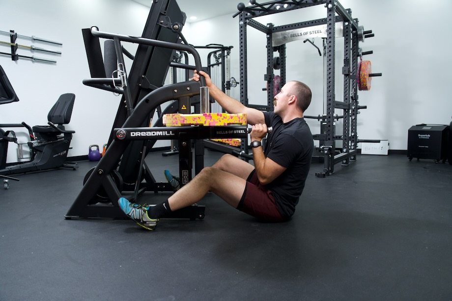 Coop adjusts one of the weights on a Bells of Steel Dreadmill.