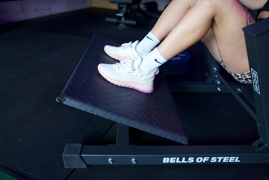 Side view of the foot plate being used on a Bells of Steel Hip Thrust Machine