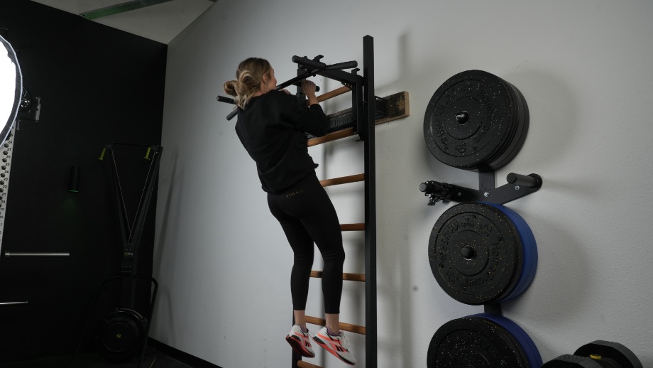 Lindsay Scheele, CPT does chin-ups with the BenchK Wall Bars.