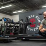 Man squatting next to several of the best treadmills for home