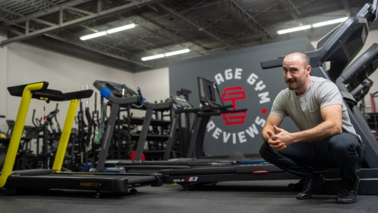 Man squatting next to several of the best treadmills for home