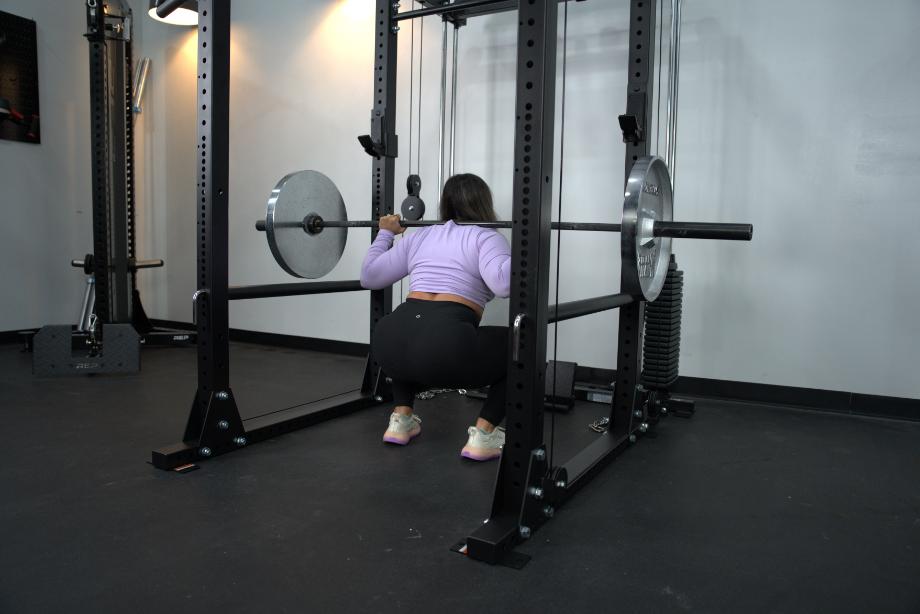 Woman performing back squats using the Body-Solid GPR400 Power Rack