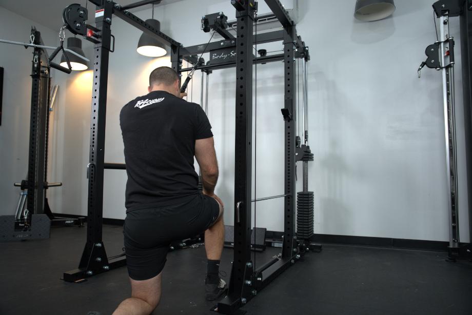 Man using the Body-Solid Functional Trainer Rack for unilateral work