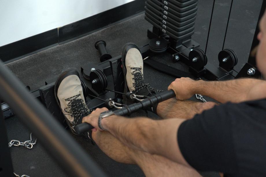 Man performing low rows on the Body-Solid Functional Trainer Rack