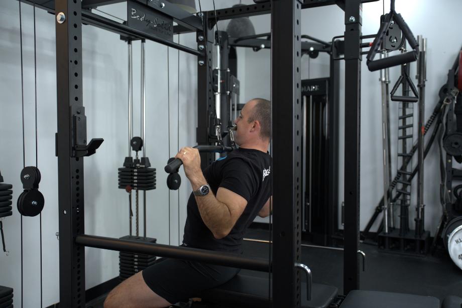 Man using the lat pulldown of the Body Solid Functional Trainer and Power Rack