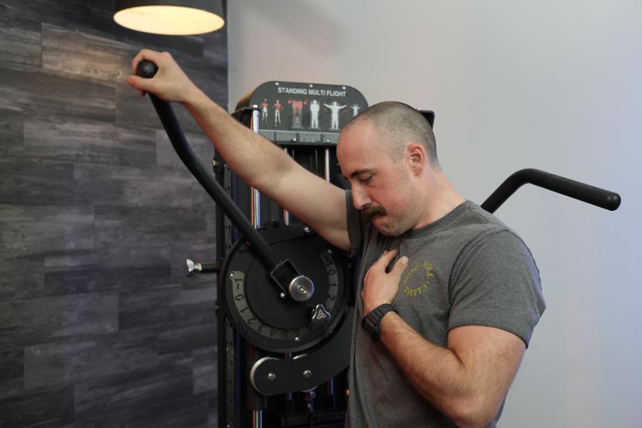 Man doing front raises with the Bolt Fitness Valkyrie