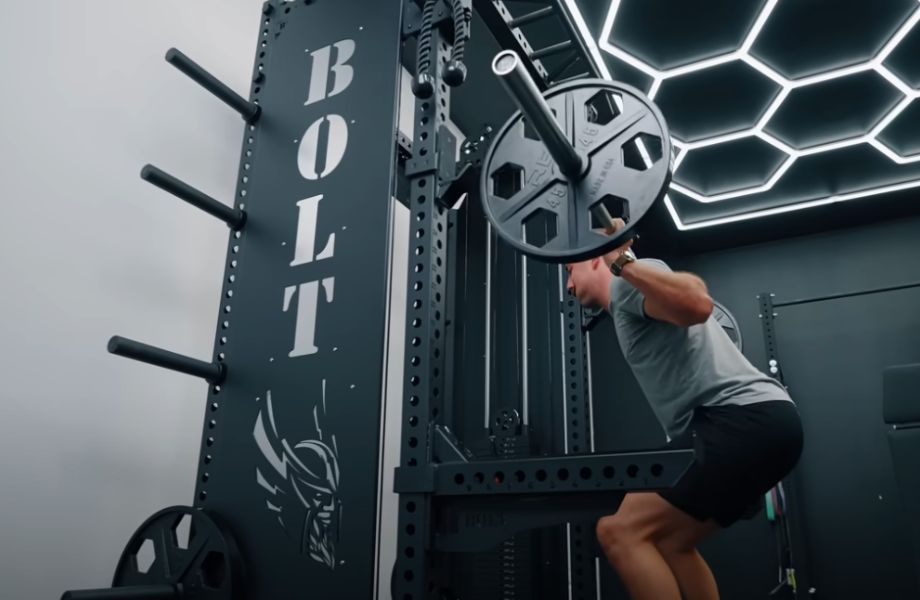 Man squatting with spotter arms in the Bolt Warlord Functional Trainer