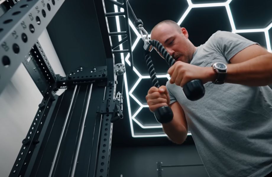 Man performing tricep pushdowns on Bolt Warlord Functional Trainer