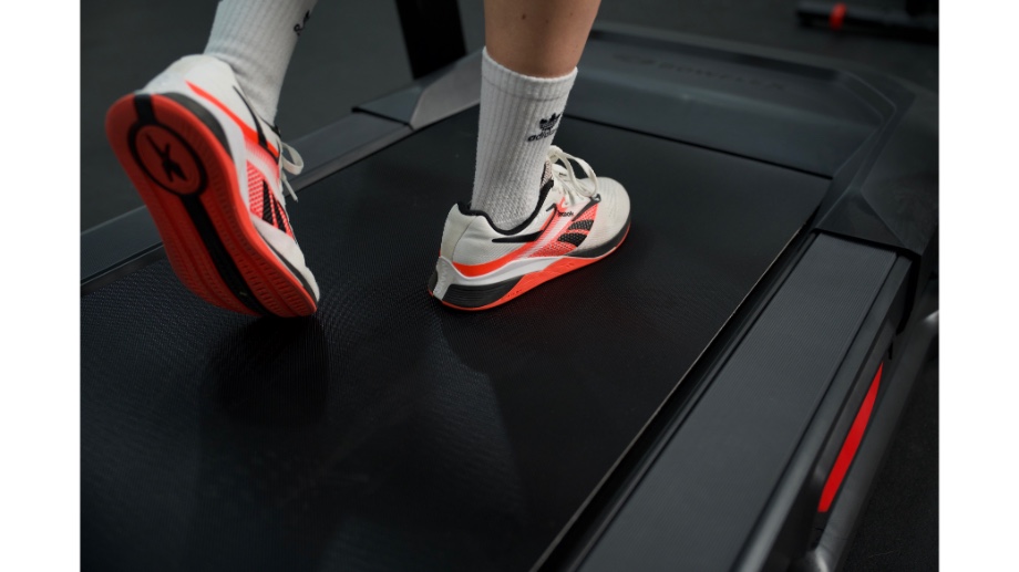 Person walking on running deck of the Bowflex BXT8J treadmill