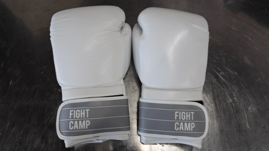 A pair of white boxing gloves from FightCamp