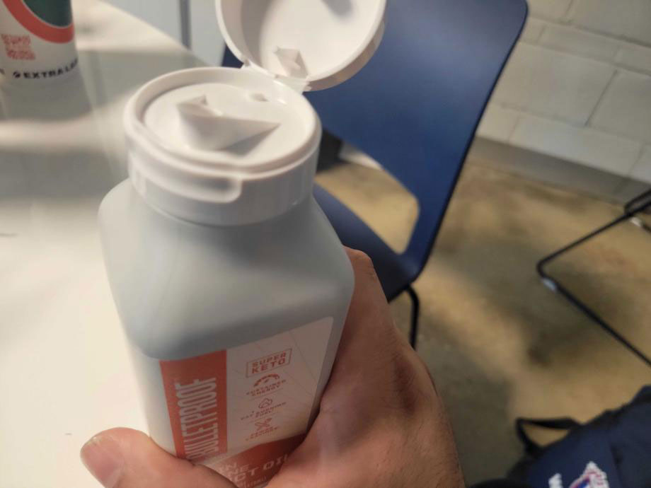 A person holds a container of  Bulletproof MCT Oil