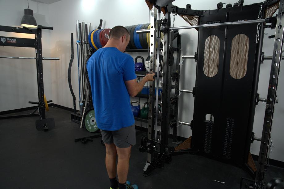 Man performing curls on the BRUTEforce UX1 Functional Trainer