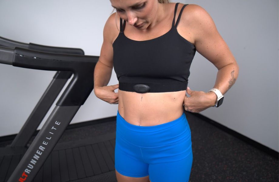 Woman with COOSPO heart rate monitor around her chest
