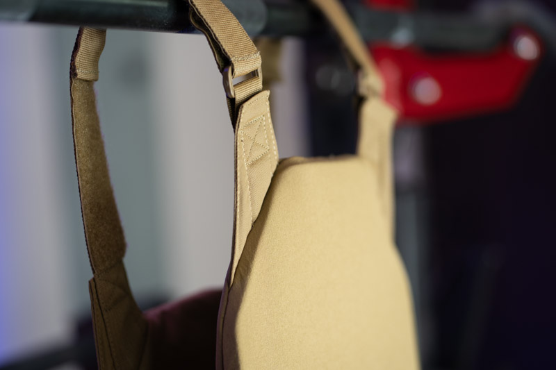 A closeup of the Rogue Plate Carrier hanging off a pull-up bar