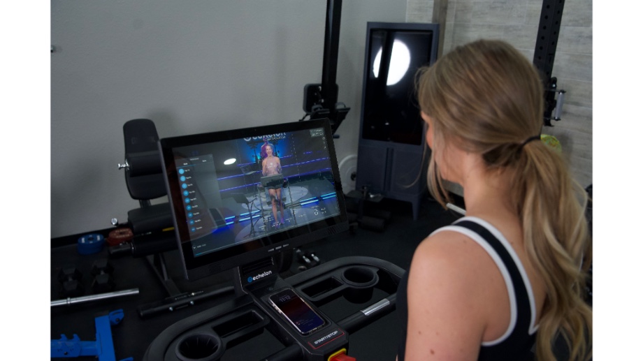 Woman following along with Echelon programming on the Stride 8s treadmill