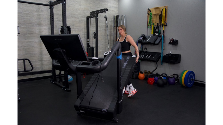Woman moving the Echelon Stride 8s treadmill