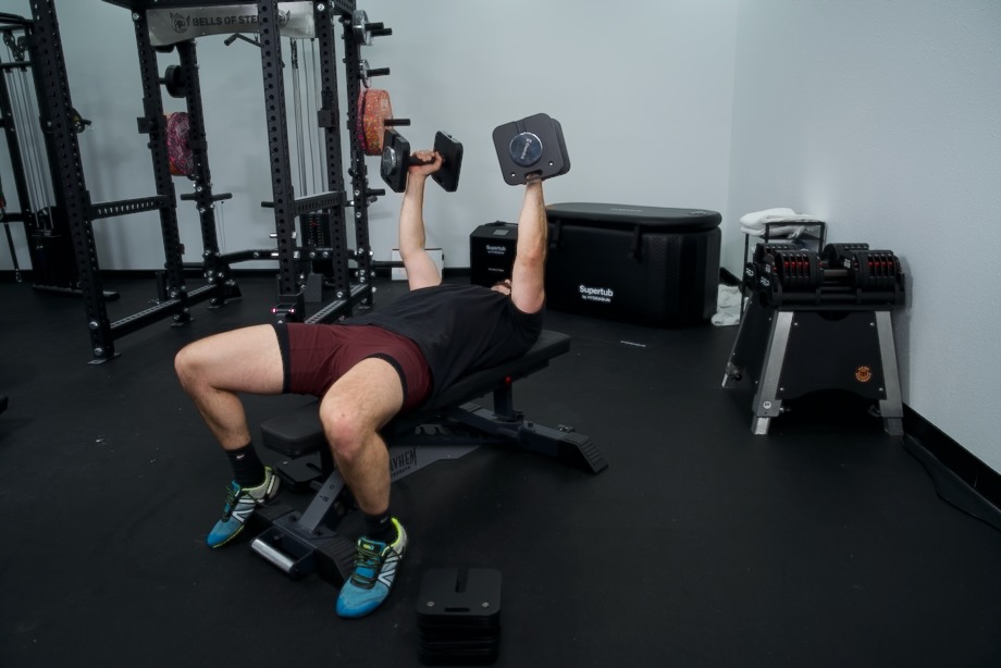 Coop doing overhead presses on a bench with a pair of Eisenlink Adjustable Dumbbell.