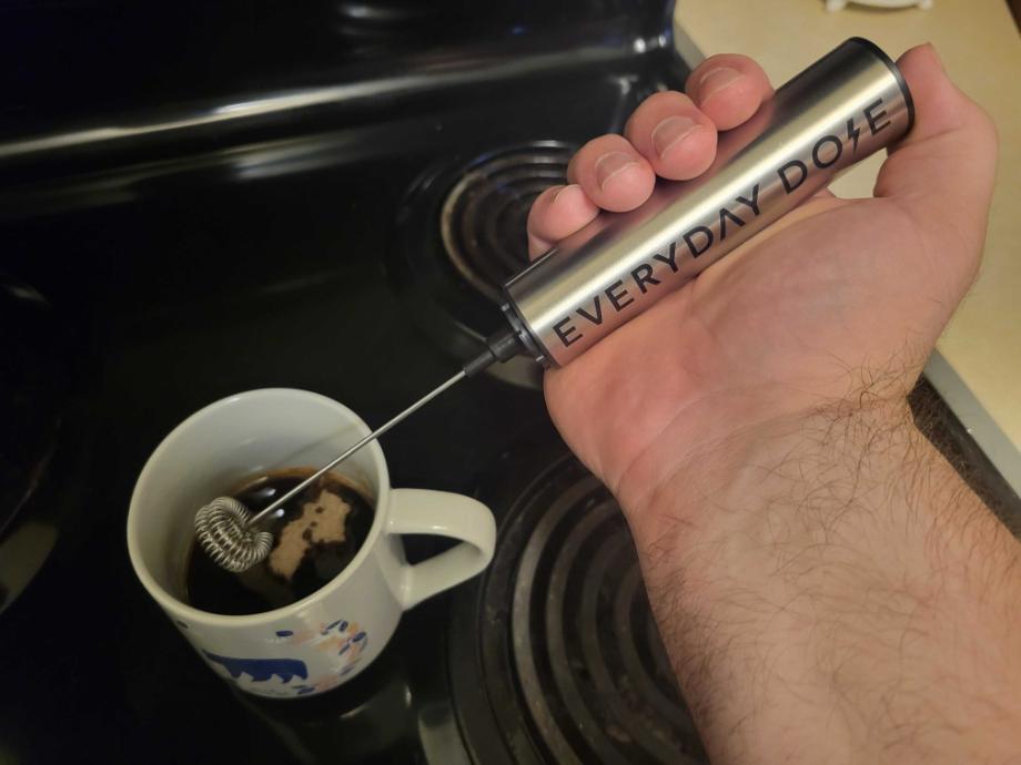 Caine WIlkes holds up the Everyday Dose coffee frother