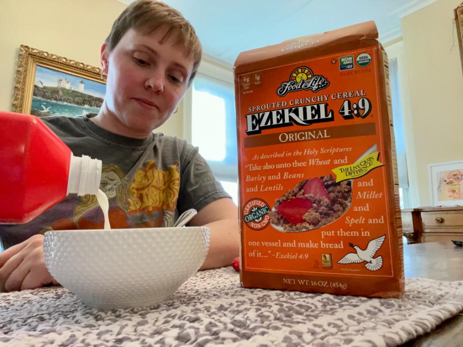 A woman pours milk over a bowl of Ezekiel 4:9 Sprouted Crunchy Cereal.