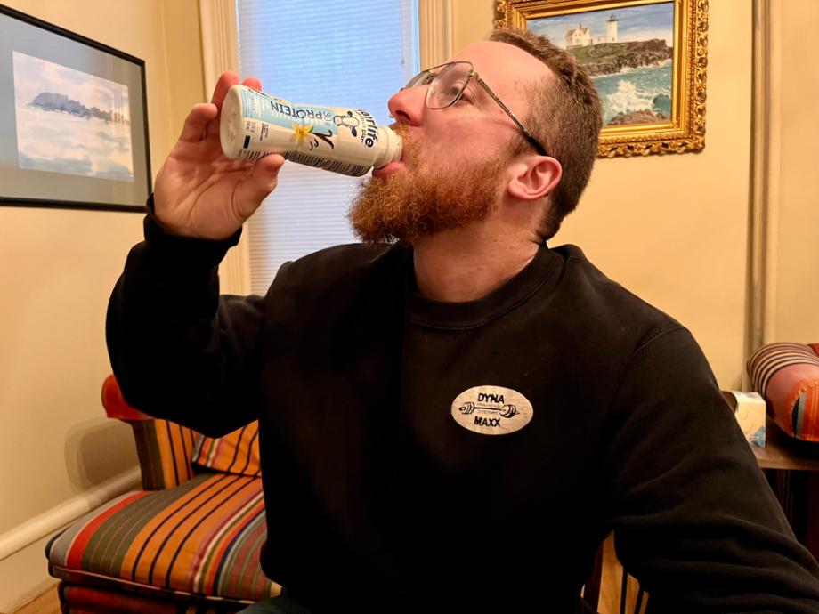 A man drinks a Fairlife Nutrition Plan Shake.