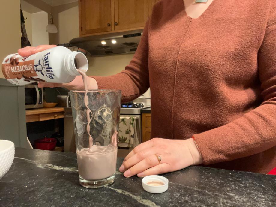 Our tester pours a Fairlife Nutrition Plan Shake into a glass.
