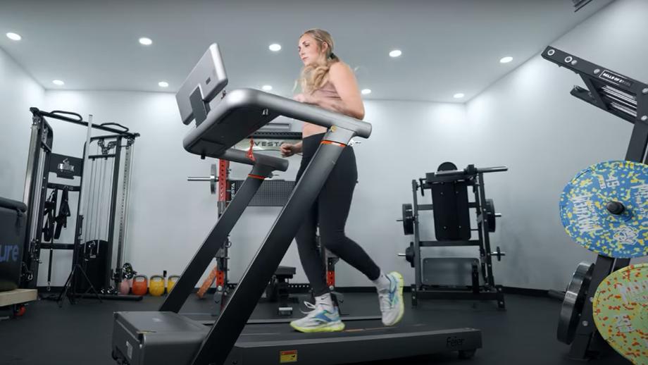 Lindsay Scheele, CPT is shown jogging on a FEIER Star 100 Treadmill.