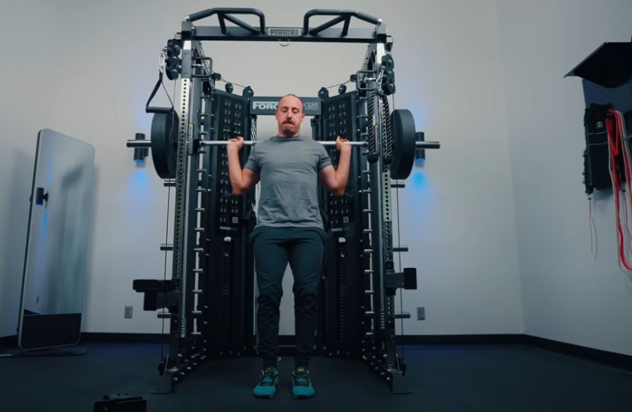 Man squatting on smith machine in Force USA G15