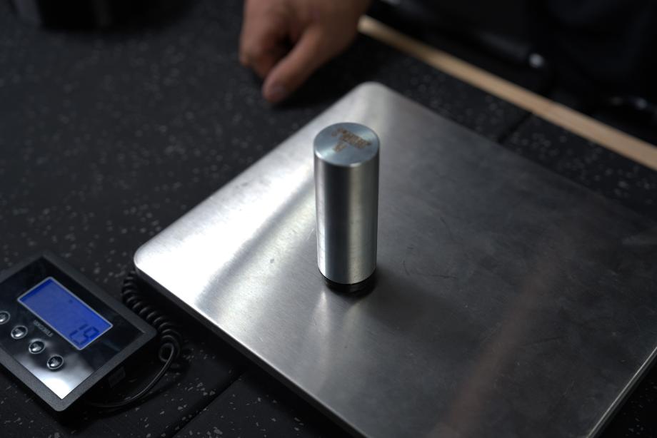 A Weigh It Out Revolver bullet weight being weighed on a scale