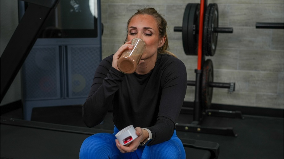 A person drinking Ghost Vegan Protein.