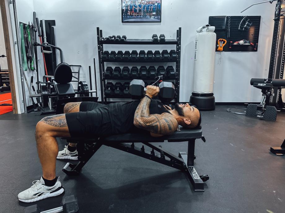 Stephen Sheehan, CPT, CNC, doing a hex press on a Giant Lifting Adjustable Weight Bench