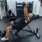 A man doing a fly on an incline with the Giant 2X Adjustable Bench