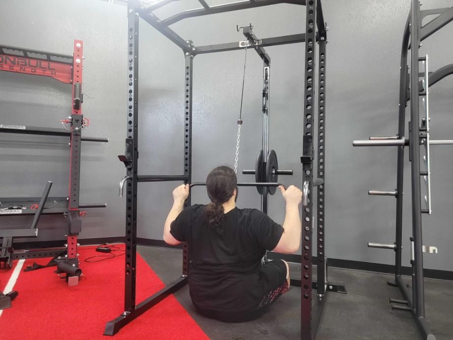 Man using the lat pulldown machine attachment on the Giant Garage Gym Rack 2.0