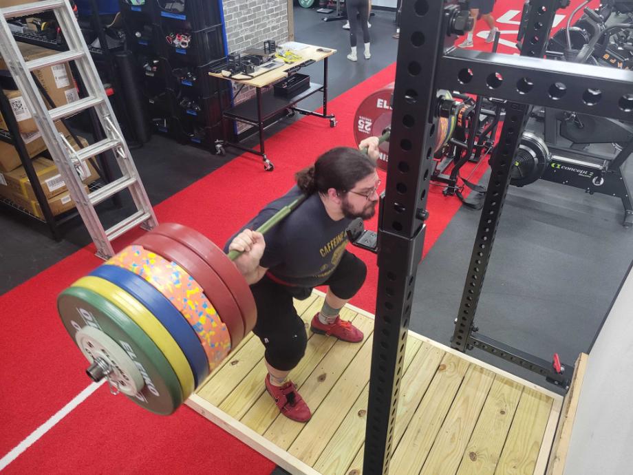 Man squatting nearly 600 pounds for the Giant Lifting Wall Rack 2.0 review