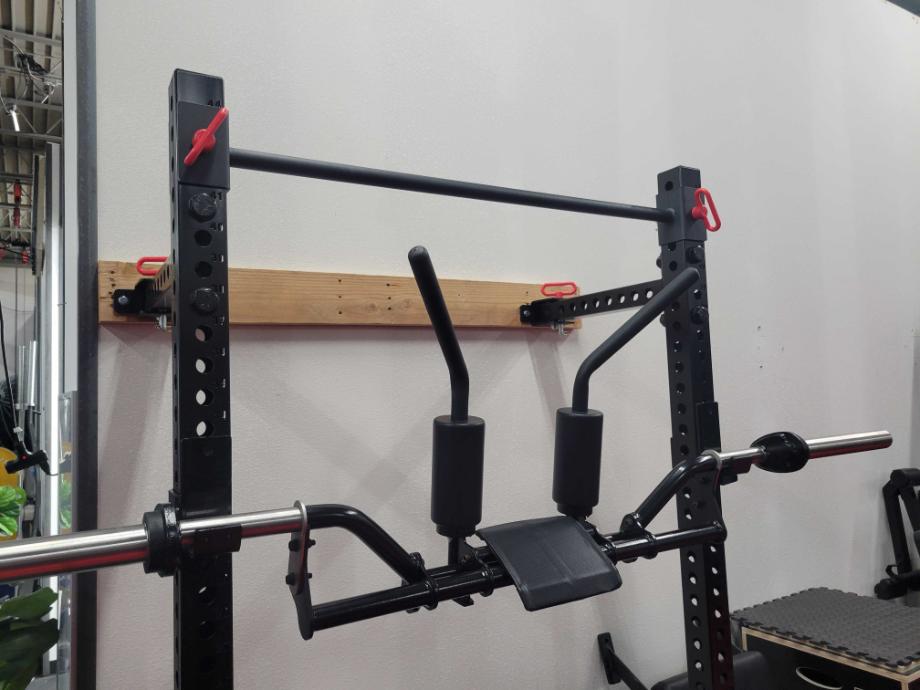 A safety squat bar racked on the Giant Lifting Wall Rack 2.0 