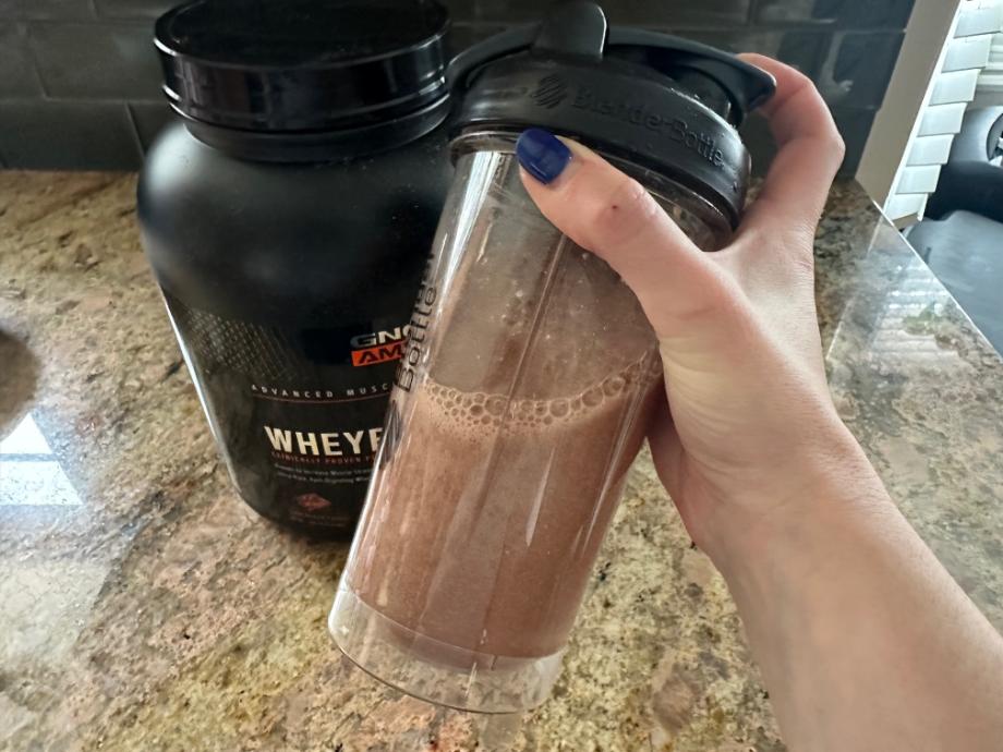 Shaking up a serving of GNC AMP Wheybolic Protein Powder.