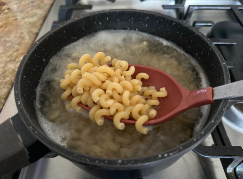 Goodles pasta cooking in a pot.