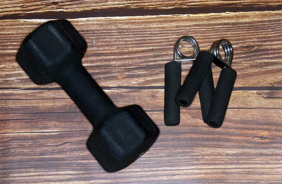 Grip strengtheners next to dumbell