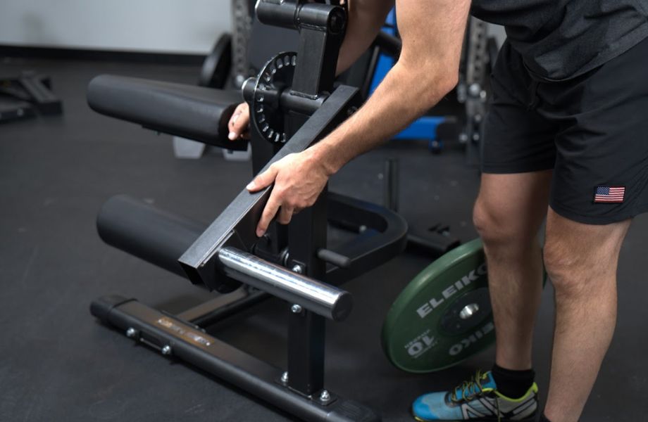 Coop adjusting the lever arm of a Gronk Fitness Leg Machine