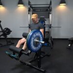 A person preparing for the Gronk Fitness Leg Machine review