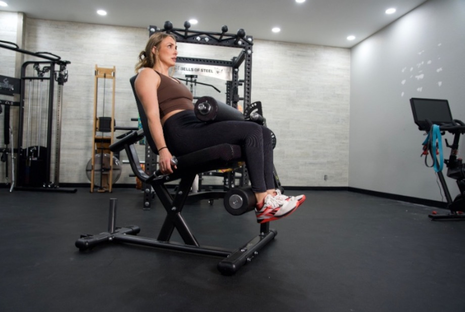 Lindsay does leg curls on the Gronk Fitness Leg Machine